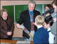 Thomas Feller receives gifts from Russian students as he visits their classroom.