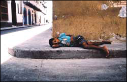 Common street scene-kids like this find a familiar corner to call home for the night in most undeveloped cities worldwide.