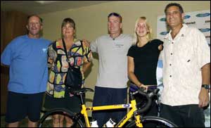Bethany (second from right) receives her new bike from the Challenged Athletes Foundation (CAF). From left are her parents, Tom and Cheri Hamilton; Willie Stewart, noted amputee athlete; and Bob Babbitt, CAF vice president. Photo by Phil Mislinski, courtesy of the Challenged Athletes Foundation.