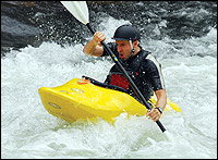 Mark Eberhart, a transfemoral amputee, rides the rapids in his kayak, one of many extreme sports in which he competes.