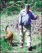 Bilateral SCOKJ wearer with polio walks in the woods with his dog. Photograph courtesy of Horton's Orthotic Lab.