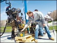 Raytheon Sarcos employees try to keep up with software engineer Rex Jameson as he uses the exoskeleton to load a pallet during a demonstration. Photographs courtesy of Raytheon.