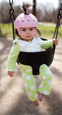 infant in cranial helmet