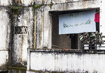 stained building with clothesline