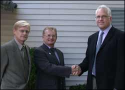 Tom Thullen, CO (left), and David Thullen, CPO, shake hands with OrPro President Michael Hamontree (right).