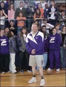 Coach Steelman is pictured with the Lonoke High School girls' track team and boys' football team.