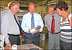 Bob Arbogast, center, president of Ohio Willow Wood, discusses the Pathfinder® foot with U.S. Congressman David Hobson, left, and Pickaway County Commissioners, Glenn Reeser and Ula Jean Metzler.