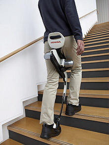 A user tackles stairs using Honda's assisted walking device.