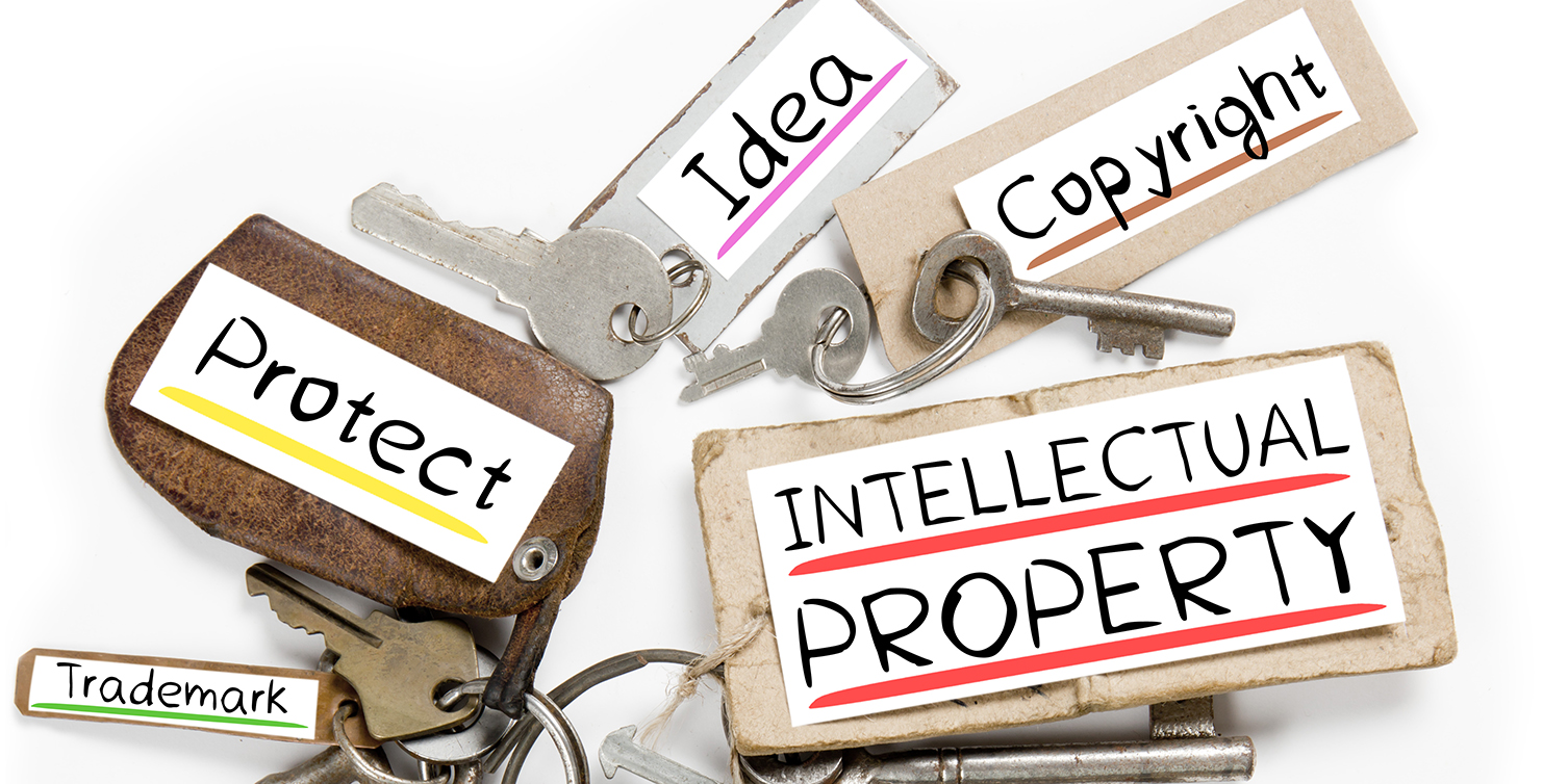 Photo of key bunch and paper tags with INTELLECTUAL PROPERTY conceptual words