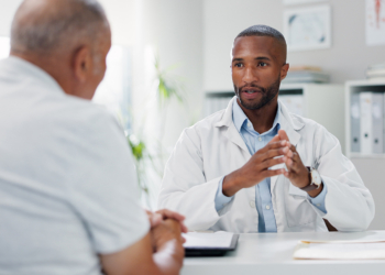 Doctor, patient and consultation with conversation for healthcare, people in office with advice or instructions for medication. Treatment, medical info and elderly care with communication at clinic.