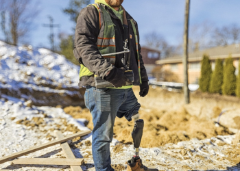 Adkins says OI made him much more confident at his job, allowing him to navigate diverse terrain, including sand, mud, and snow. Photograph courtesy of Perry Prosthetics.